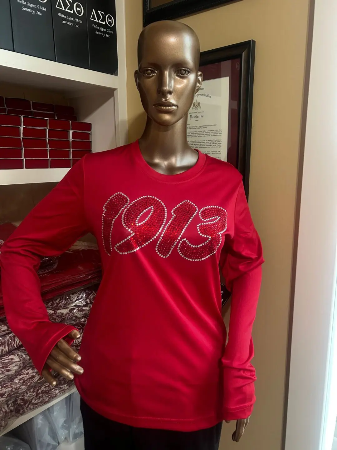 Mannequin wearing red "1913" long-sleeve shirt.